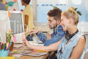 Happy business people looking at computer