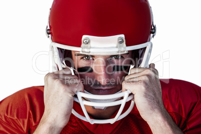 Portrait of rugby player wit hands on helmet