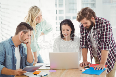 Creative business people working on laptop