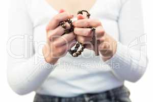 Mid section of woman holding rosary beads