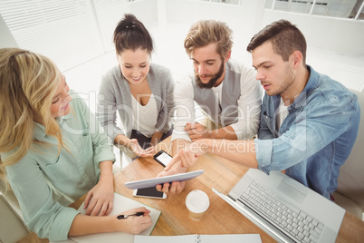 High angle view of business people using digital tablet