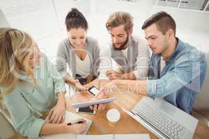 High angle view of business people using digital tablet