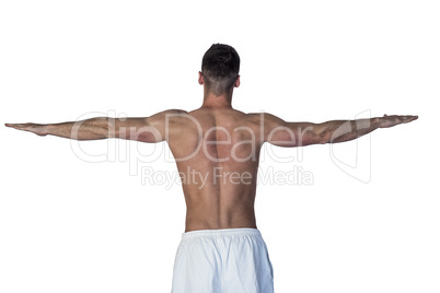 Rear view of a man stretching his arms