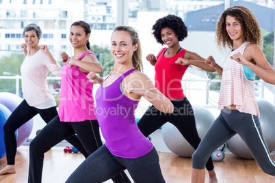 Portrait of women exercising with clasped hands and stretching