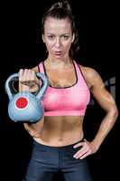 Portrait of woman exercising with kettlebell