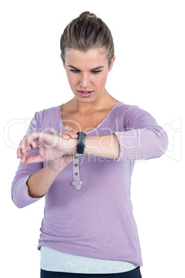 Young woman checking wristwatch