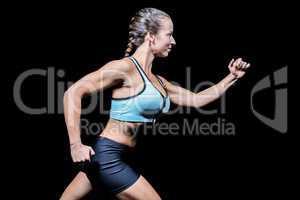 Side view of female athlete running