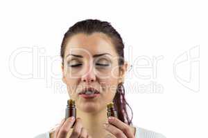 Close-up of woman smelling bottles of medicine