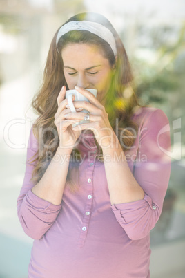 Woman sipping coffee from cup