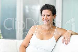 Portrait of woman sitting on sofa
