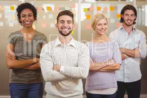 Portrait of smiling business team with arms crossed in office