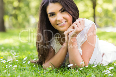 Portrait of pretty woman lying on grassland