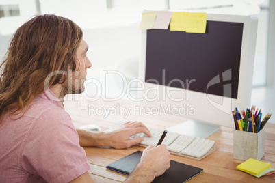 Man working on computer with graphics tablet