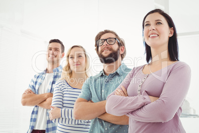 Smiling business people standing in row with arms crossed