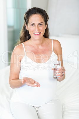 Portrait of happy woman with pills