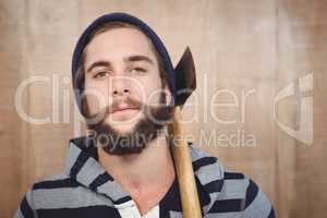 Close-up portrait of hipster with hooded shirt holding axe