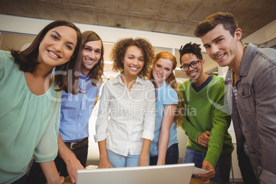 Portrait of smiling business people with laptop