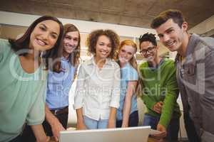 Portrait of smiling business people with laptop