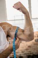 Man measuring biceps with tape