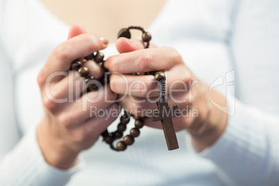 Woman holding rosary beads