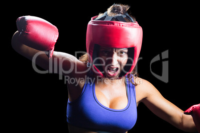 Portrait of angry female boxer with fighting stance