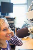 Female radio host broadcasting in studio