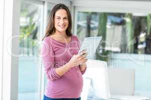 Portrait of happy woman using tablet computer