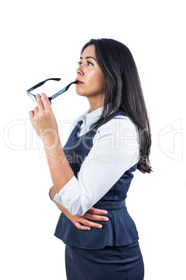 Woman holding her glasses against her lips