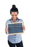 Smiling woman holding a small chalkboard