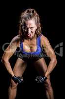 Portrait of aggressive female boxer flexing muscles