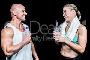 Cheerful athlete friends with water bottle