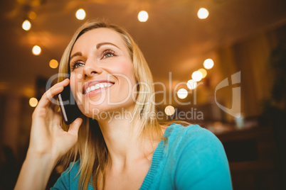 Close-up of happy young woman using mobile phone