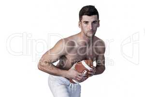 Portrait of shirtless rugby player posing with the ball