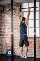 Rear view of man doing pull ups