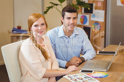 Business people using laptop at desk