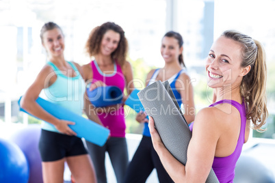 Portrait of a cheerful woman in fitness studio