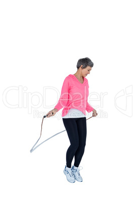 Mature woman exercising with jump rope