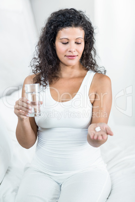 Pregnant woman taking pill