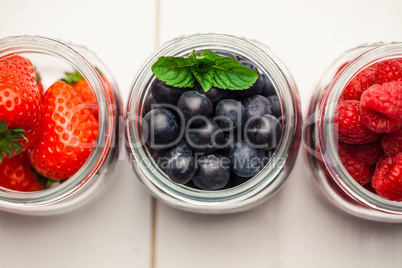 Glass jars of fresh berries