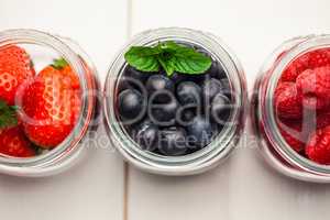 Glass jars of fresh berries