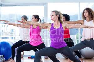 Women exercising with arms outstretched