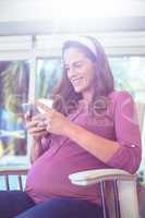 Happy woman text messaging on cellphone