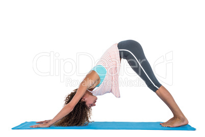 Young woman in downward facing dog position