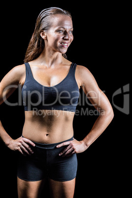 Cheerful athlete with hands on hip