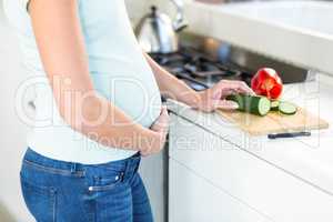 Midsection of woman with vegetables on board