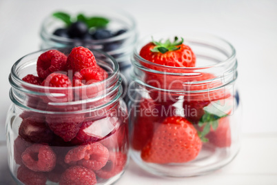 Glass jars of fresh berries