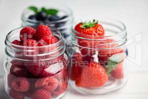 Glass jars of fresh berries