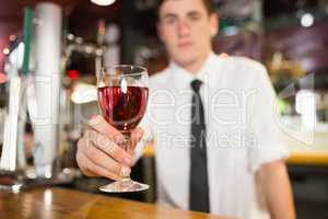 Male bartender serving alcohol