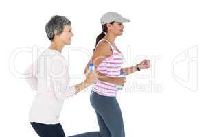 Side view of women with bottle jogging