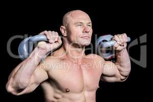 Muscular fit man holding dumbbells